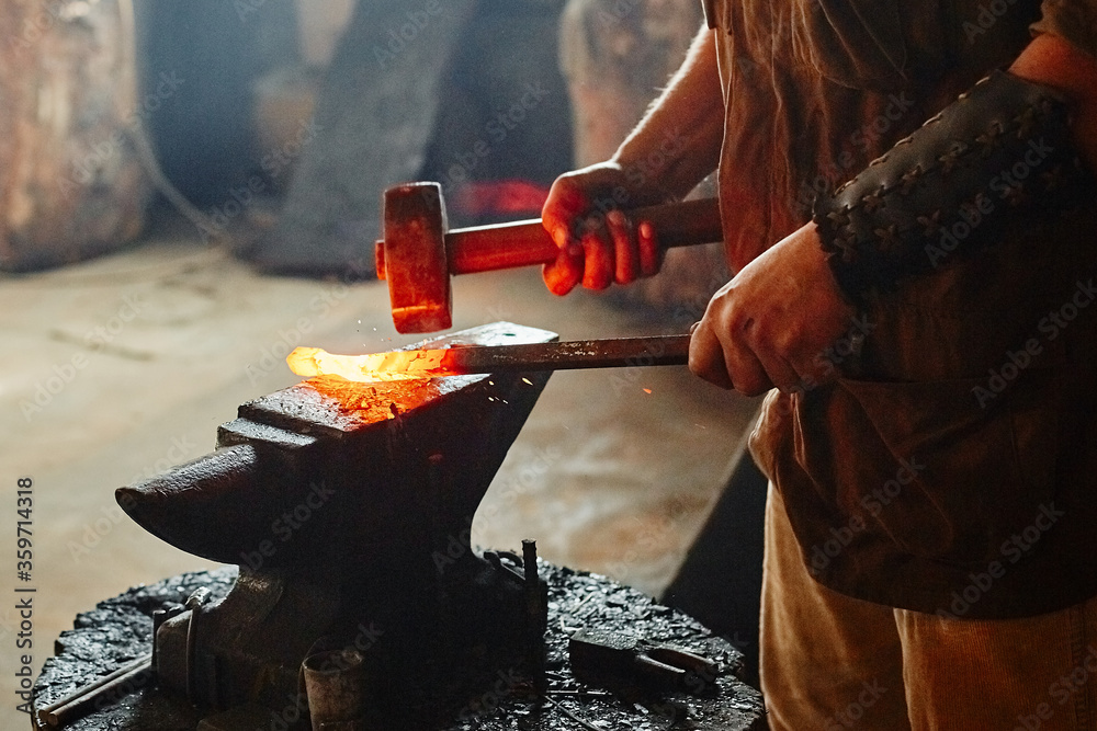 Manual work of a blacksmith in a blacksmith Shop. Hammer blows on the