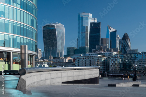 City of London financial district seen from the South Bank of the River Thames. New office towers glint in the morning sunshine.