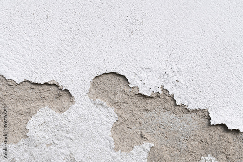 Wall damage on outdoor. Plaster and paint clog, surface damage. Peeled plaster wall background