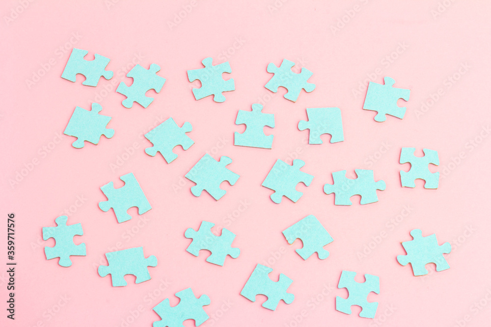 Blue puzzle pieces with empty space for your text and design on pink background. Blue puzzle pieces with empty space for your text and design on pink background.