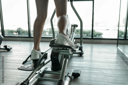 Woman exercise in gym or fitness with machine aerobic concept and healthy lifestyle  Athlete builder muscles lifestyle.