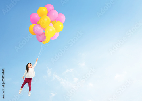Adorable asian toddler hand holding balloon flying to the sky.