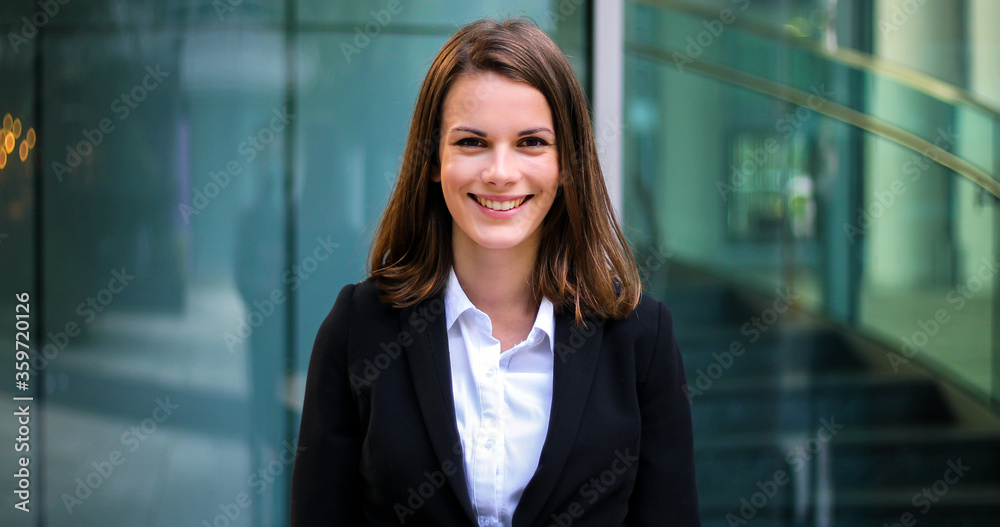 Fototapeta premium Confident young female manager outdoor in a modern urban setting