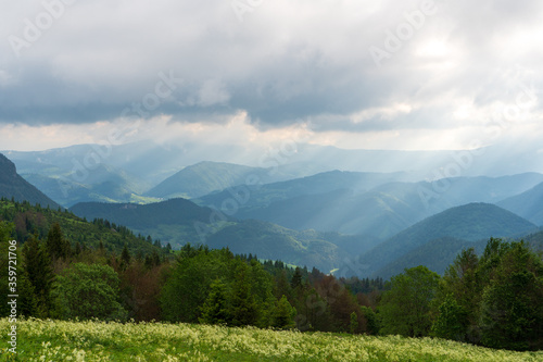 the sun pierces through the clouds, shines on the slopes of the mountains, little fatra mountains. Slovakia Europe.