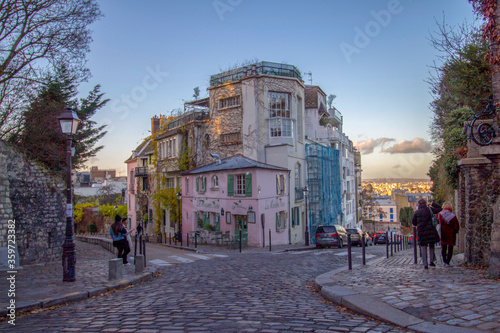 Beautiful old street with pink house at the sunrise in Paris, France © Jose D´Alessandro