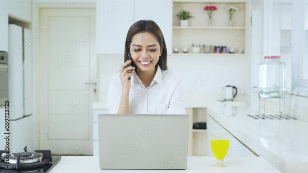 Female entrepreneur works with cellphone and laptop Female entrepreneur works with cellphone and laptop