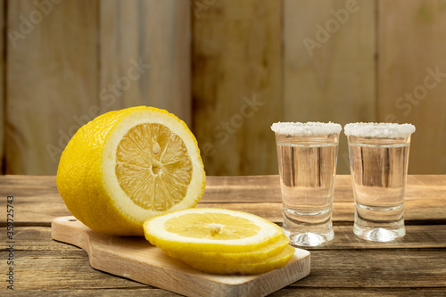 Glass with tequila on a wooden background