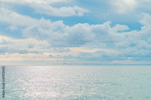 sea beach and reflection in water, cloudy blue sky background