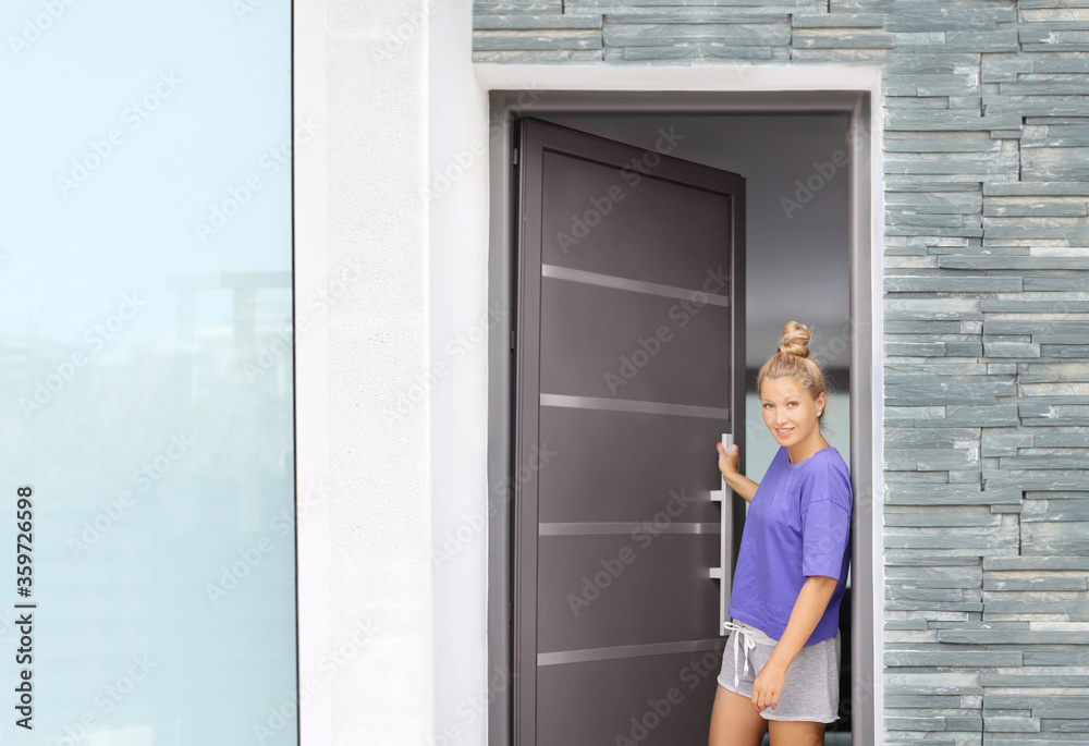 Beautiful woman opening the door of her home. Beautiful woman opening the door of her home.