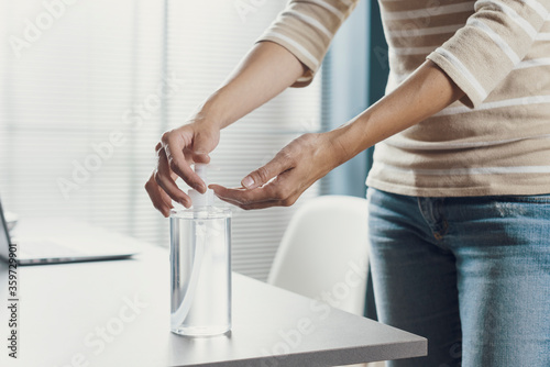 Woman applying sanitizer on her hands