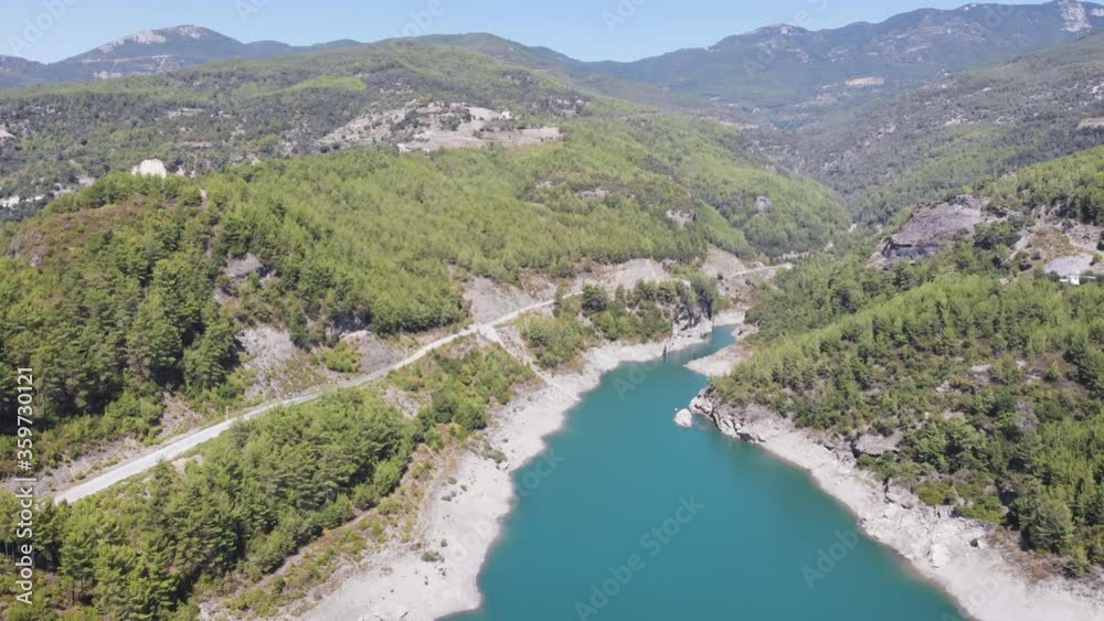 Top view on the canyon with a river in it and a road with a car driving, 4k Top view on the canyon with a river in it and a road with a car driving, 4k