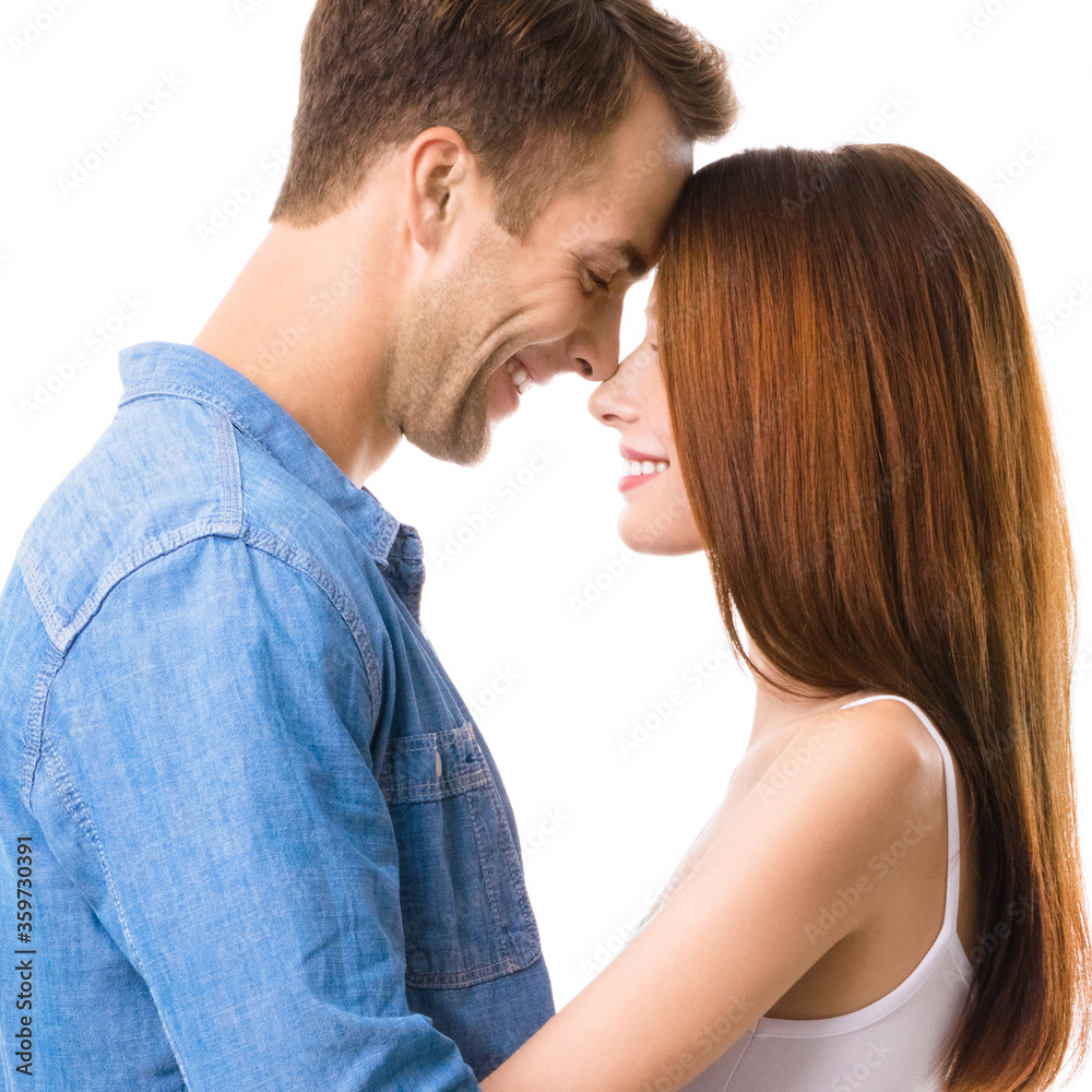 Profile side of smiling happy couple. Portrait image of standing close and looking at each other models in love studio concept, isolated over white background. Man and woman posing. Square composition Profile side of smiling happy couple. Portrait image of standing close and looking at each other models in love studio concept, isolated over white background. Man and woman posing. Square composition