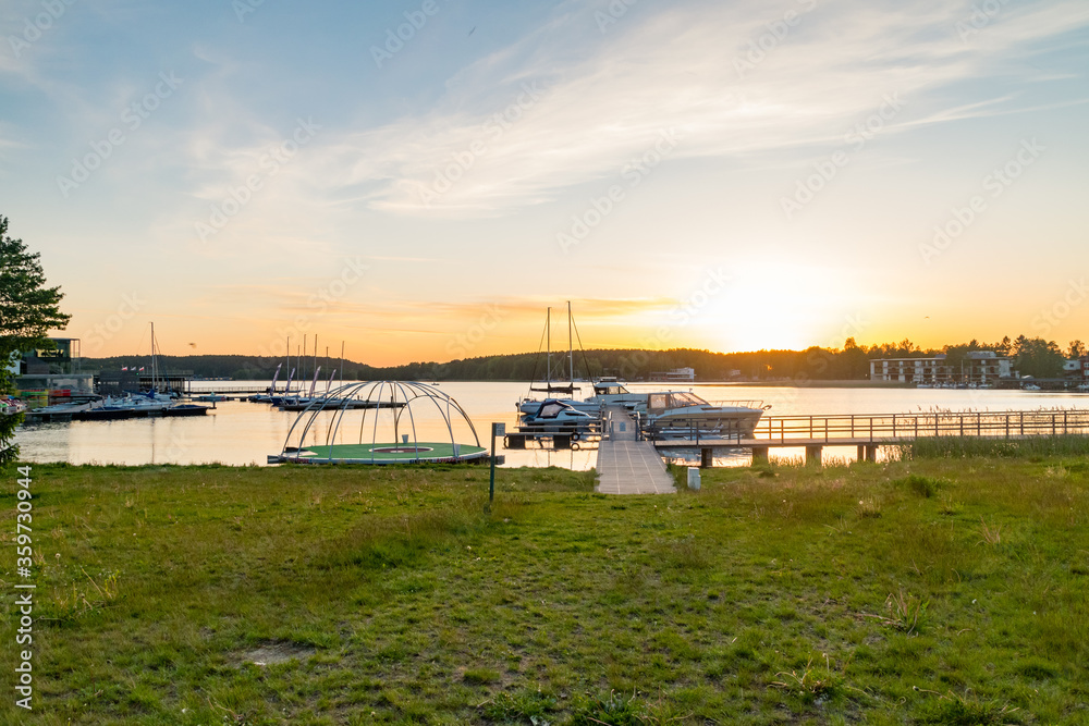 Panoramic view on Ukiel lake with marina at sunset time in Olsztyn, Poland. Panoramic view on Ukiel lake with marina at sunset time in Olsztyn, Poland.