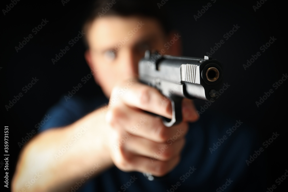 Man hold pistol. Selective focus. Self defense weapon Man hold pistol. Selective focus. Self defense weapon