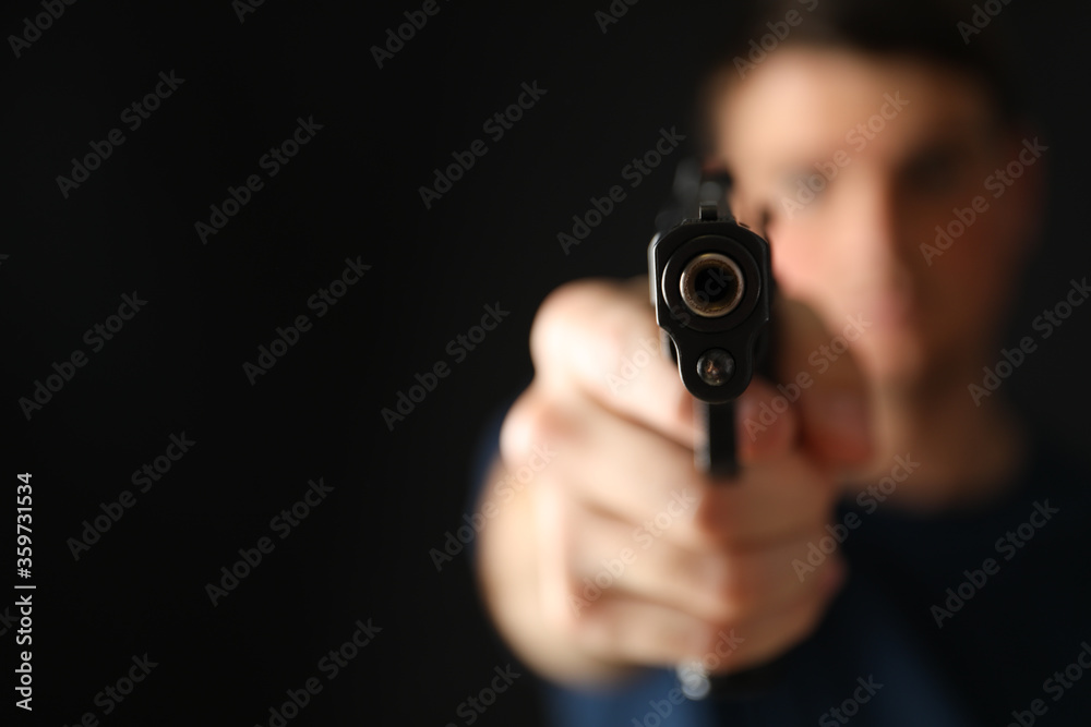 Man hold pistol. Selective focus. Self defense weapon Man hold pistol. Selective focus. Self defense weapon