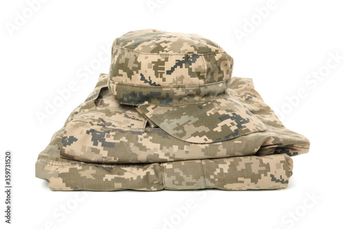 Folded military uniform and cap isolated on white background