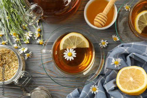 Composition with chamomile tea on gray wooden background