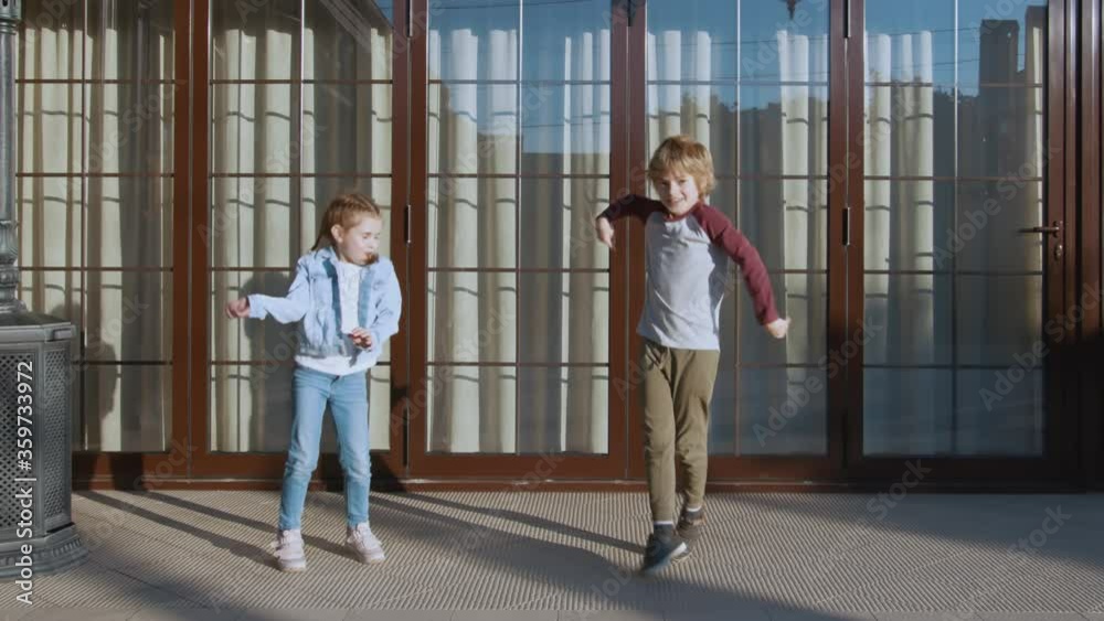Smiling dancing small girl and boy outdoors Smiling dancing small girl and boy outdoors