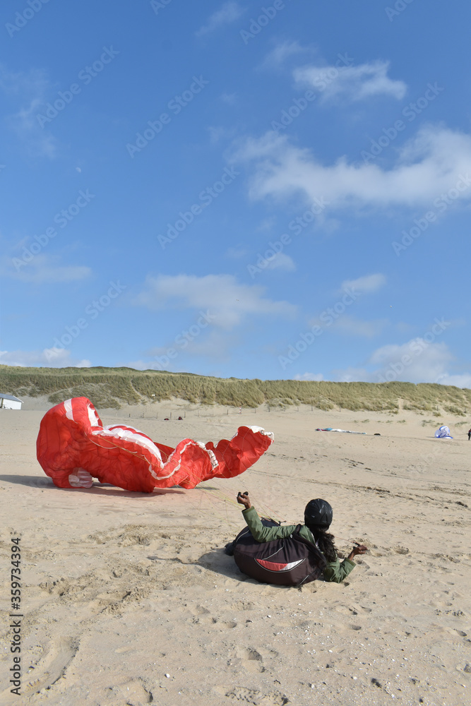 Paragliding at the beach of Katwijk aan Zee. Paraglider's making use of updraft of the dunes to stay in the air Paragliding at the beach of Katwijk aan Zee. Paraglider's making use of updraft of the dunes to stay in the air