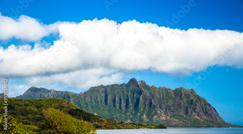 Fototapeta Naklejka Na Ścianę i Meble -  Cloudy blue sky above the Koolau mountan Range on the north shoes of the island of Oahu near the village of Panaluu, Hawaii.