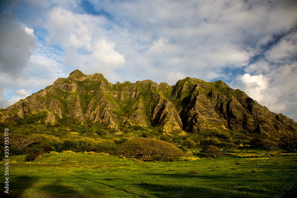 A meadow and the Koolau mountan Range on the north shoes of the island of Oahu near the village of Panaluu, Hawaii.