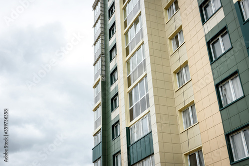 Residential buildings with balconies in the city, urban development of apartment houses.