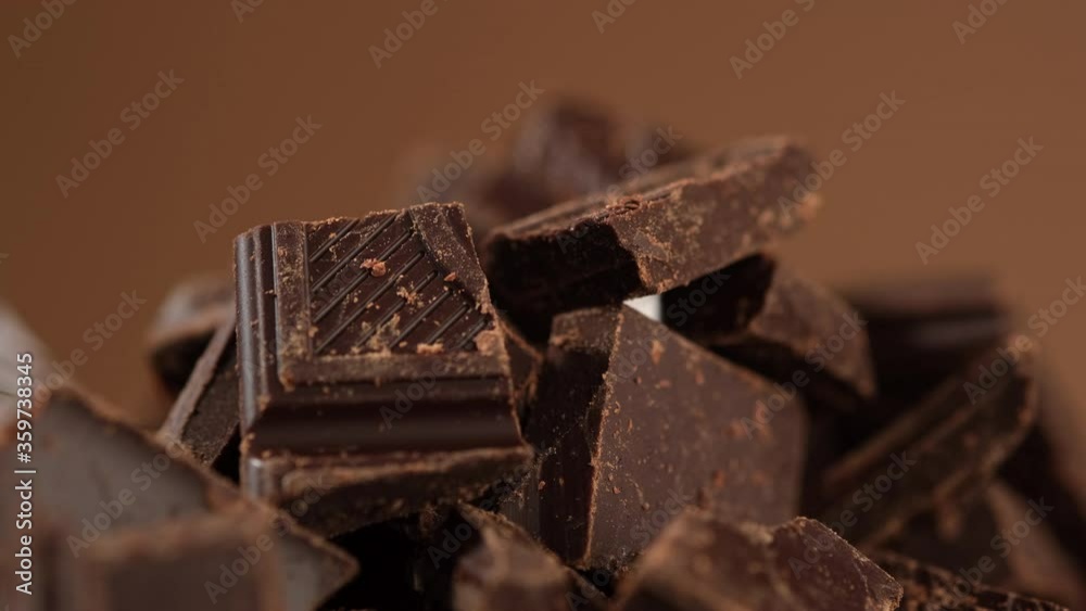 Chunks of sweet dark chocolate rotated, close up. Gourmet dessert ingredient Chunks of sweet dark chocolate rotated, close up. Gourmet dessert ingredient