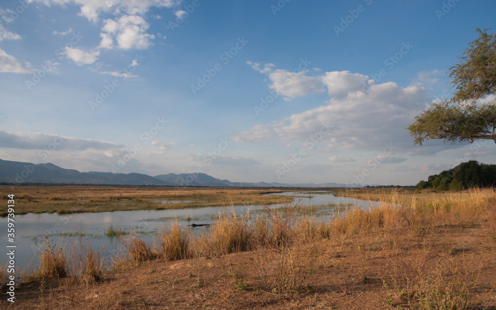 View of the Zambezi River with blue sky and clouds in Mana Pools National Park, Zimbabwe