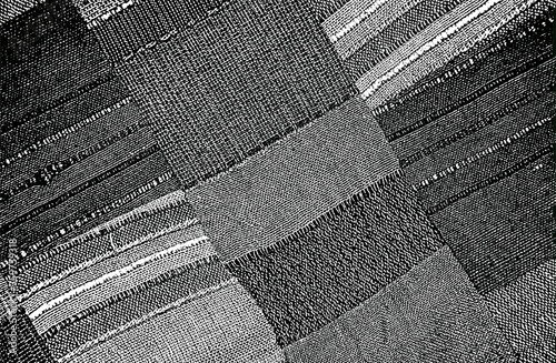 Distressed overlay texture of weaving fabric, knitted blanket with tartan ornament. grunge background.