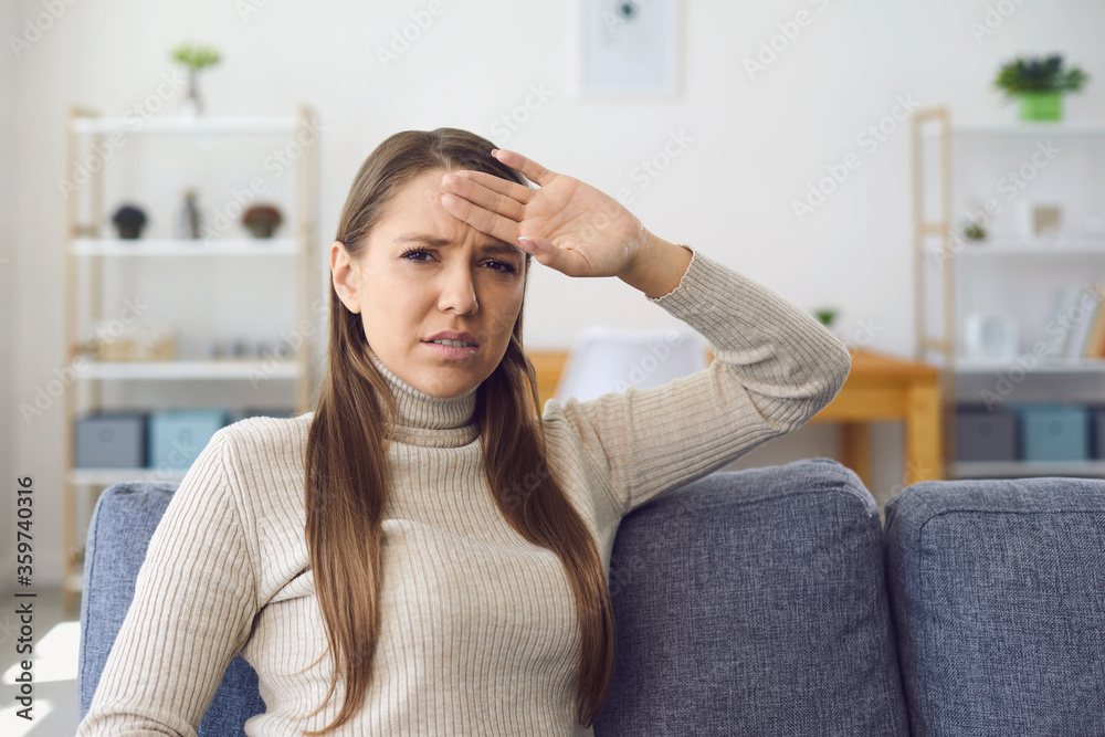 Headache. Migraine. Sick girl with a headache at home Headache. Migraine. Sick girl with a headache at home