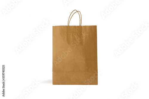 Recycled kraft brown paper shopping bag isolated on white background. Mock up.