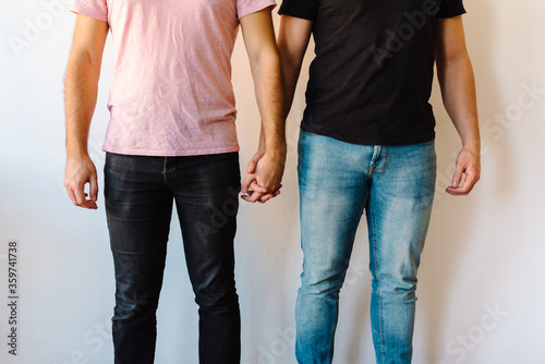Two homosexual men holding hands.