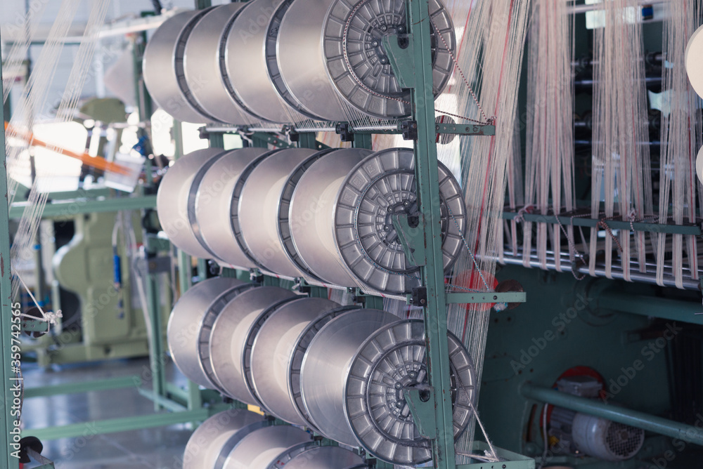 mechanical equipment at a garment factory. thread manufacturing tools. mechanical equipment at a garment factory. thread manufacturing tools.