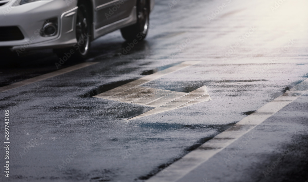 Long white arrow to left on wet road ,scene after hard rain fall in city. Long white arrow to left on wet road ,scene after hard rain fall in city.