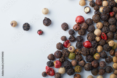 A mixture of peppers. Black, white, red polka dots. Isolated on a white background. The selected sharpness