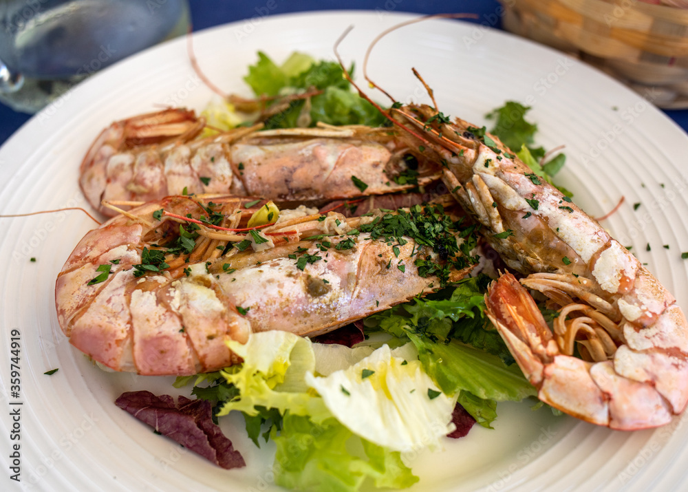 fried big shrimps with lettuce on white plate fried big shrimps with lettuce on white plate