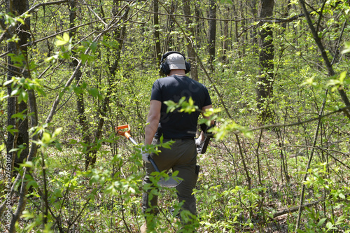  Digger with a metal detector in the forest