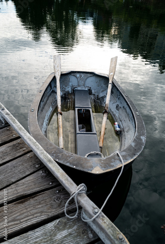 Old wooden row boat reflected on a dock on Bainbridge Island, Washington © Steve Azer
