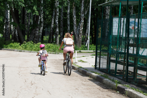 young couple riding bikes in park