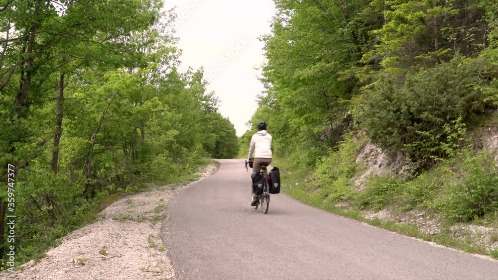 Man cycling through calm road, Zumberak national park, Croatia. Man cycling through calm road, Zumberak national park, Croatia.