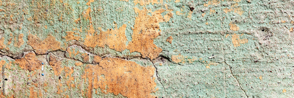 Fototapeta premium Texture of a concrete wall with cracks and scratches which can be used as a background