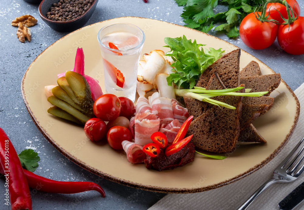 Cold vodka with pepper, pickled vegetables and brown bread