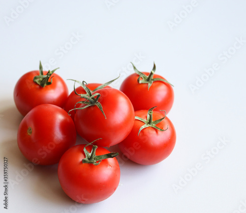 ripe tomatoes on a white background close up