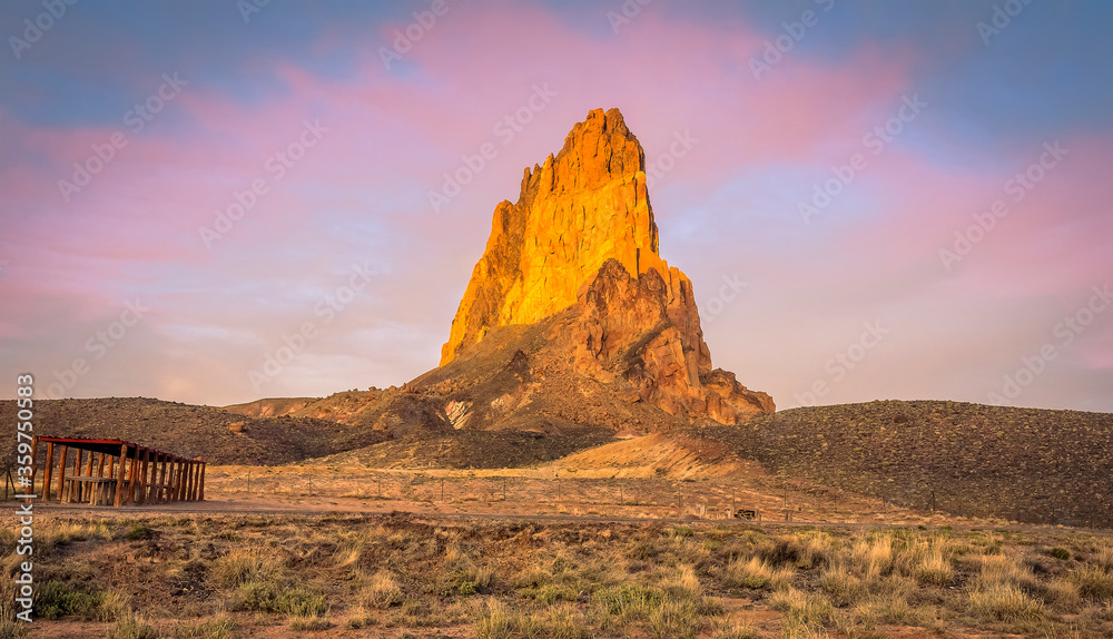 Agathla Peak, north of Kayenta, Arizona illuminated by the golden light of the setting sun