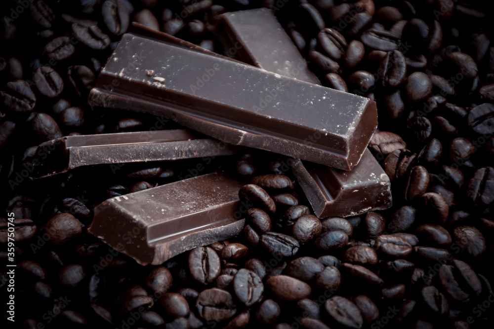 sweet and tasty dark chocolate bars surrounded by coffee beans sweet and tasty dark chocolate bars surrounded by coffee beans