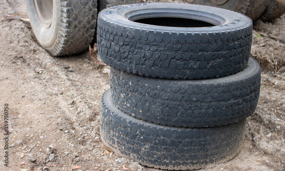 Three old tires stacked, close-up of a truck tire. Environmental pollution. Dump tires