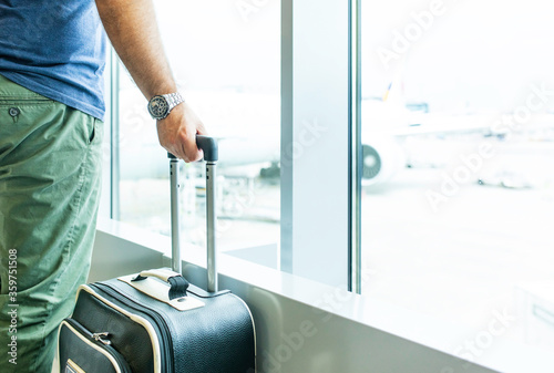 Waiting at the airport, COVID-19 Pandemic border closures, man waiting for the plane returning home city after being stuck in a foreign country as governments have restricted travel to stop the corona photo