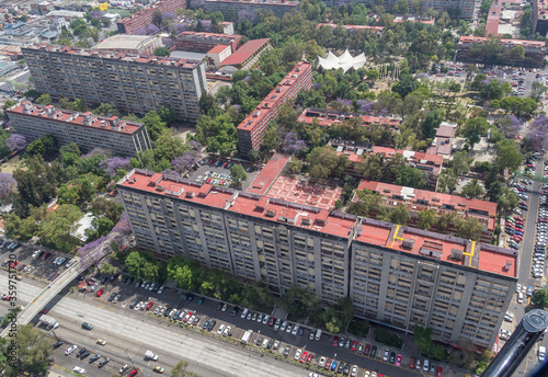 Aerial view of Tlatelolco apartment residential complex in Mexico City with green areas with booming jacarandas photo