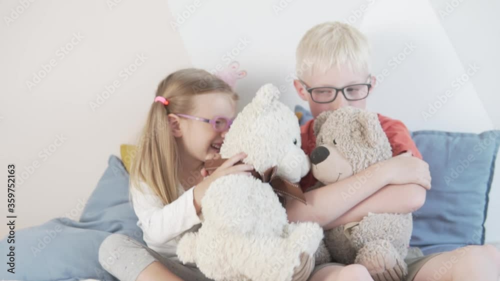 Cute kids in glasses hug toy teddy bears. Cute kids in glasses hug toy teddy bears.
