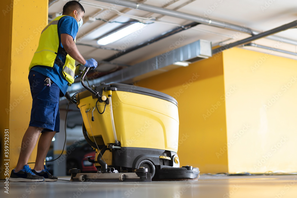 cleaning professional working in garage cleaning with sweeping machine cleaning professional working in garage cleaning with sweeping machine
